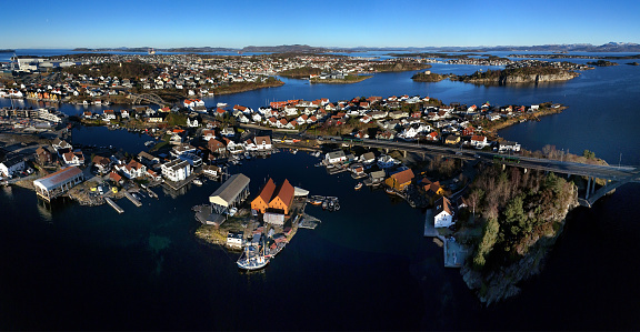 Aerial panoramic view of the harbour bay area with small marinas and bridges connecting the small Islands just before sunset in Stavanger, Norway