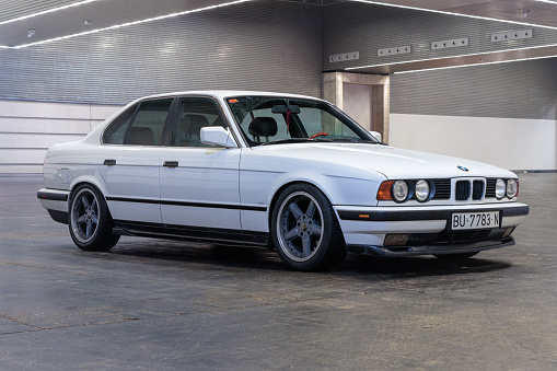 Bilbao, Spain-November 11, 2023: BMW 5 (E34),  third generation of the BMW 5 Series in indoor parking