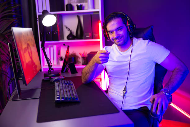 istock Smart gaming streamer looking at camera with pose playing shooting. Surmise. 1954513749