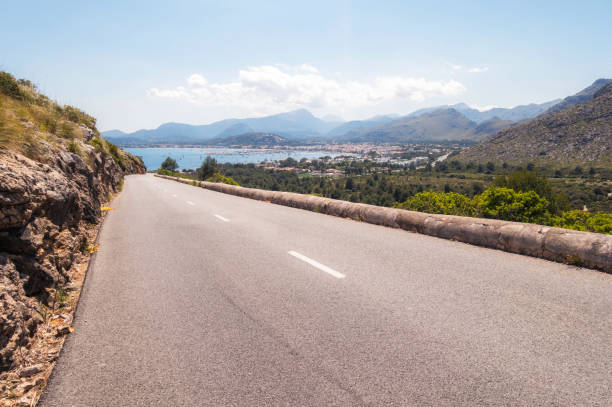 A long road leading down towards the popular seaside town of Puerto Pollensa in Mallorca.