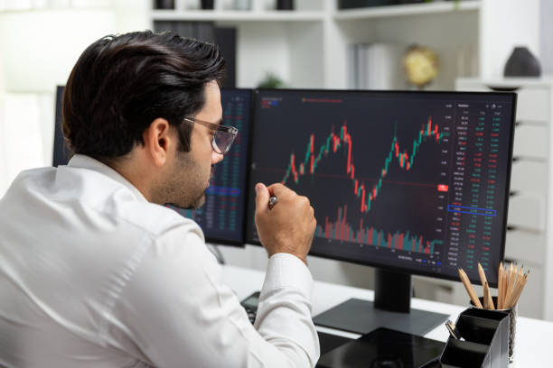 istock Trader analyzing in dynamic stock exchange investment screen on pc. Surmise. 1954520794