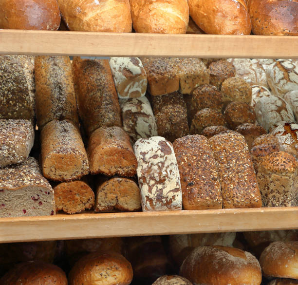 istock Fresh bread on shelves in a bakery store 1954528240