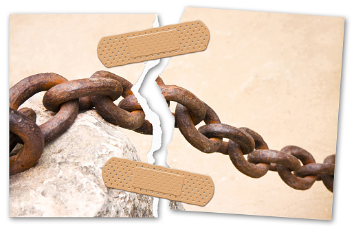 Repair the bond - concept image with a ripped photo of an old rusty metal chain linked with adhesive bandage