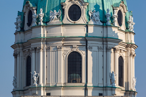Detail of the dome of Karlskirche with its sculptures and green copper roof in Vienna, Austria