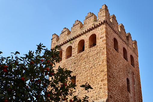 Kasbah tower structure with blue sky at Place Outa El Hamam in Chefchaouen, Morocco, Africa.