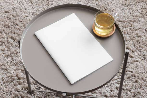 istock Magazine mockup with a cup of tea on the beige table. 1954566428