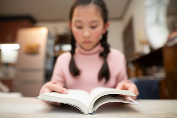 istock girl reads a book at home 1954578562