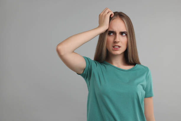 istock Embarrassed woman on grey background. Space for text 1954592469