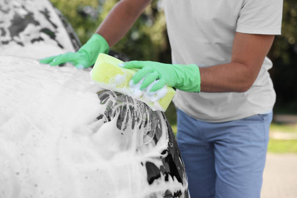 istock Man washing car with sponge outdoors, closeup 1954592999