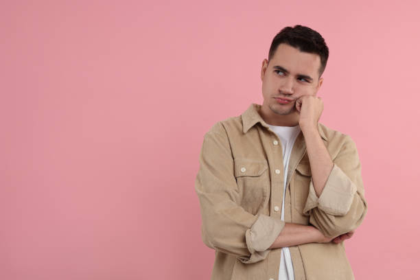 istock Resentful man on pink background, space for text 1954596173