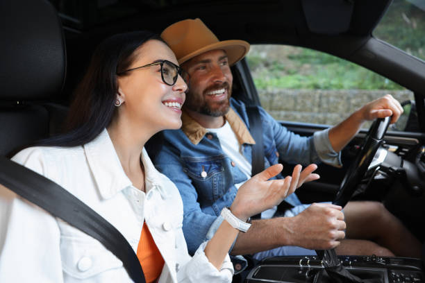 istock Happy couple enjoying trip together by car 1954596176