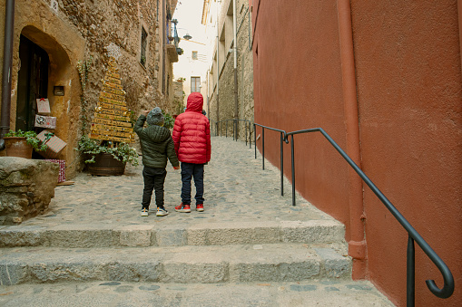 Chilren strolling through Peralada, Girona, Spain