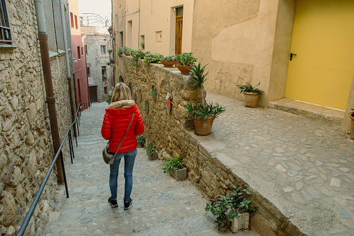 Woman strolling through Peralada, Girona, Spain