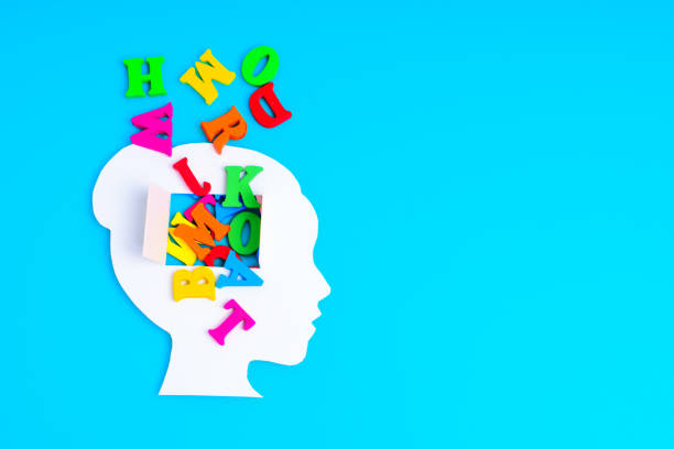 istock Woman Head Paper Shape with Open Mind and Vibrant Letters 1954614656
