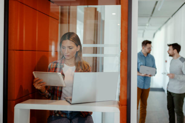 istock Female Freelance Working From Co Working Office Booth 1954626601