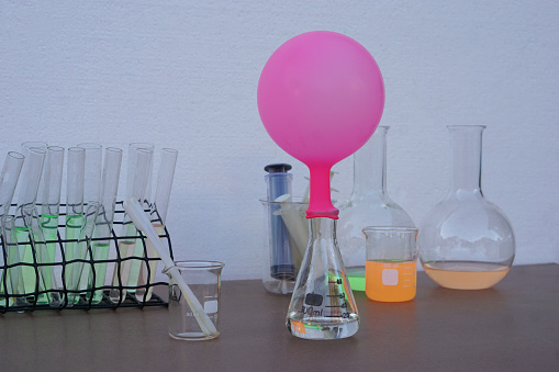 Science experiment , pink inflated balloon on top of transparent test bottle. The experiment about air or gas reaction.by using baking soda and vinegar.Concept, Science Education