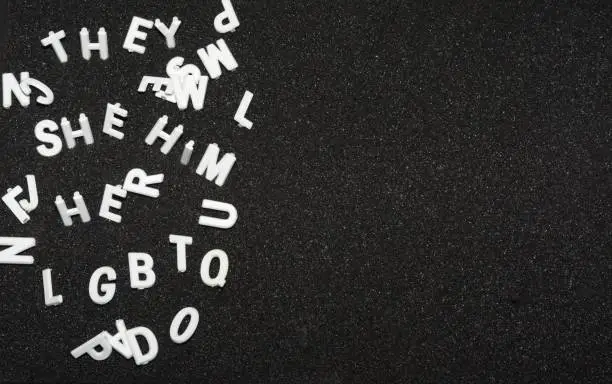 Photo of Scattered white letters on black