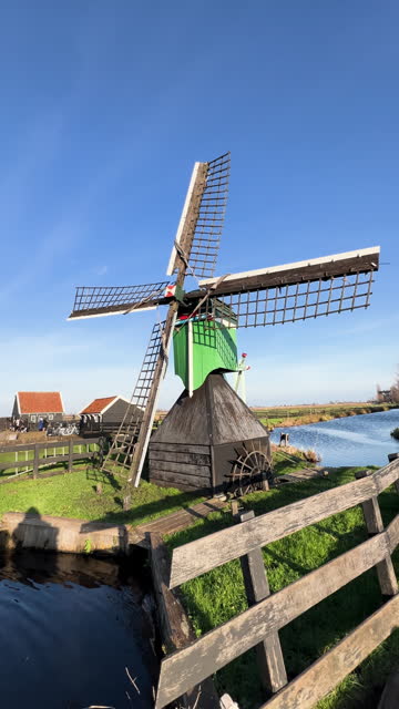 Traditional windmills in Zaanse Schans in the Netherlands, Spinning mills, Rural landscape with windmills in the Netherlands, Ancient wooden windmills in Zaanse Schans, the most popular tourist attraction in the Netherlands