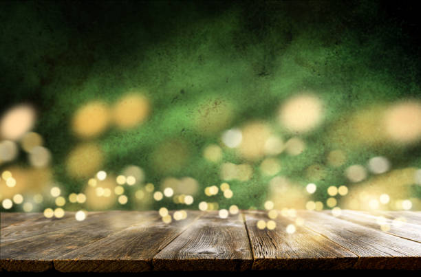 istock Happy St. Patricks Day background. Abstract green background with empty wooden table and glitter lights background. St. Patricks Day holidays wallpaper. 1954649046