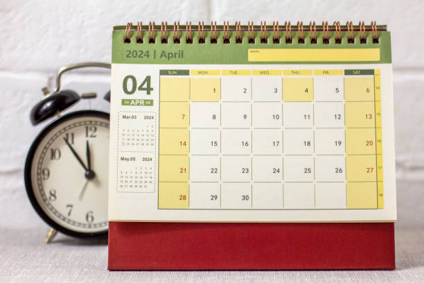 istock Desk calendar for April 2024 and a clock on the table. 1954657020