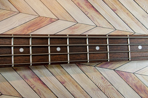 Close up of a wooden electric guitar at the recording studio