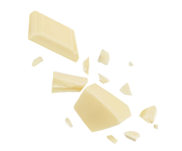 istock  Levitating white milk chocolate chunks isolated on white background. Flying Chocolate pieces explosion, shavings and cocoa crumbs Top view. Flat lay 1954661448