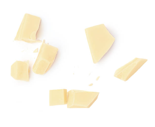 istock White Milk Chocolate  isolated on white background. Broken Chocolate pieces top view 1954661453