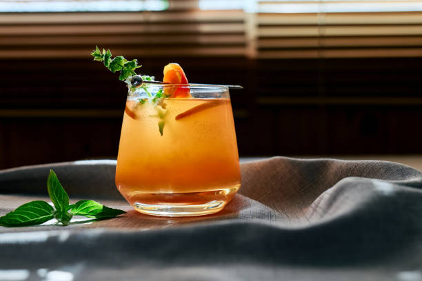 istock Summer refreshing grapefruit drink or alcoholic cocktail with grapefruit slices, ice and herbs. Citrus detox drink. 1954664157