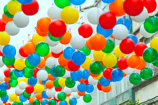 Traditional festival ,rows of multicolored balloons,  street decorations forming a canopy, low angle close-up view. Vilalba, Galicia, Spain.