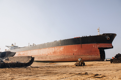 Unloading operation of project  cargo with port heavy lift cranes A crane on a large cargo ship docks loading a new diesel-electric locomotive.  at Laem Chabang Port