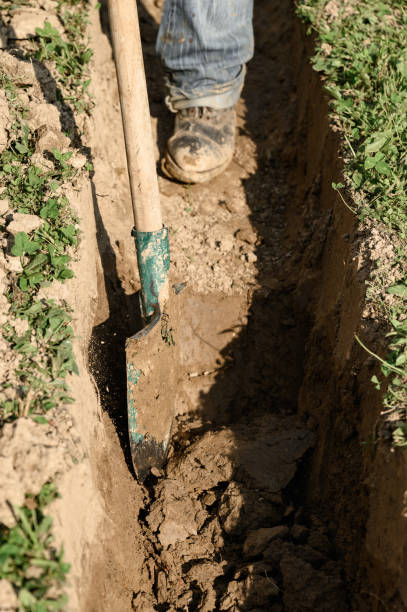 istock A man shovels a trench for drainage and sewage. 1954688707