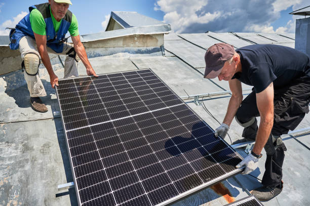 istock Workers building solar panel system on roof of house. Men installing photovoltaic solar module 1954691388