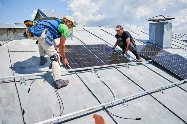 istock Workers building solar panel system on roof of house. Men installing photovoltaic solar module 1954691397