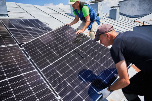 istock Workers building solar panel system on roof of house. Men installing photovoltaic solar module 1954691410