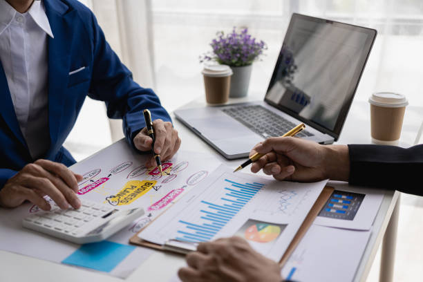 istock Successful presentation explaining the sales growth graph. Report on good results Inspire workers Multiethnic team in conference room with business team. Close-up shot 1954697880