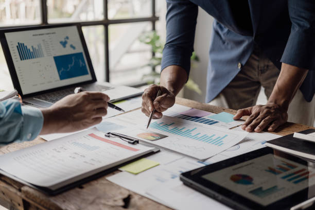 istock Successful presentation explaining the sales growth graph. Report on good results Inspire workers Multiethnic team in conference room with business team. Close-up shot 1954697885