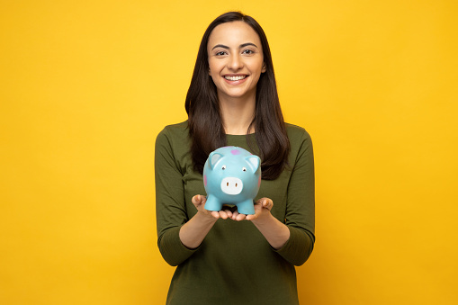 Photo of lovely person hands hold money bank pig isolated on yellow background