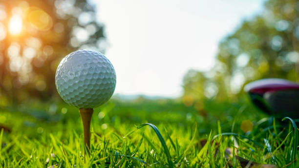 istock Golf ball on tee in beautiful golf course at sunset background. 1954775112