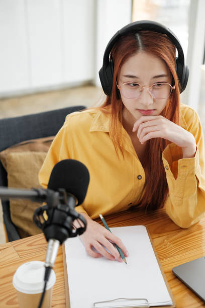 istock Female podcaster making audio podcast from her home studio 1954776274