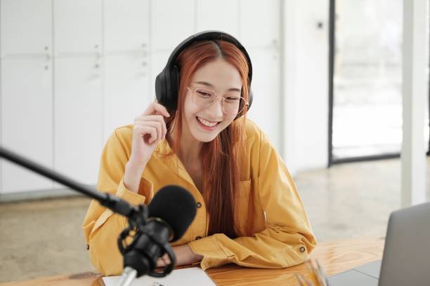 istock Live Podcast Session with Smiling Female Host 1954776311
