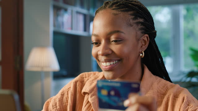 Woman, credit card and home with computer for online shopping, e learning or fintech payment. Happy, African student with study loan, course registration and internet banking for e commerce on laptop