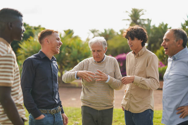istock Multi generational men having fun together at city park - Multiracial community 1954785358