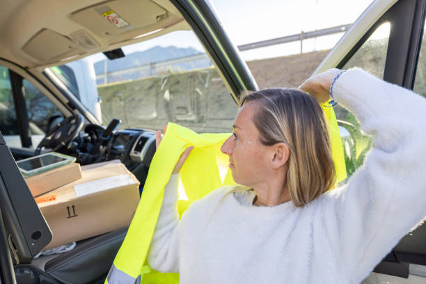 istock Female courier driver out for delivery, Delivering packages by van 1954801473