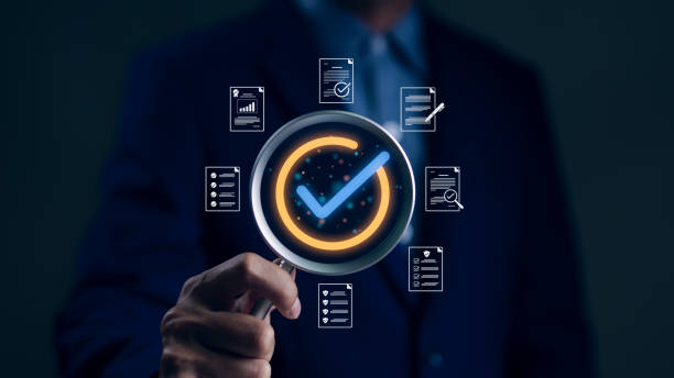 Businessman hand holding magnifying glass focusing standard quality control certification assurance guarantee symbol. Quality management with Quality Assurance and Quality Control. Standardization,