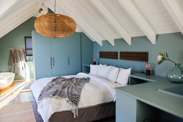 istock Comfortable attic bedroom of a luxury home 1954823741