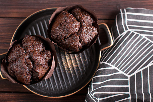 Making muffin cupcake in the kitchen. Chocolate pastries on a plate