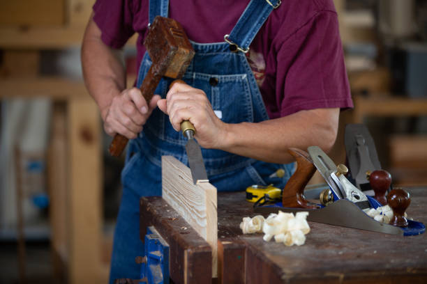 Carpenter working with equipment on wooden table. Carpenter working on woodworking machines in carpentry shop. man works in a carpentry shop.