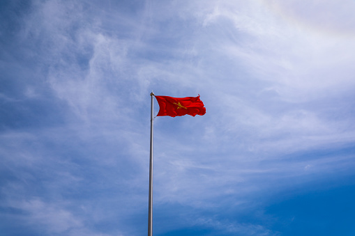Real National Flag of Vietnam with blue sky.
