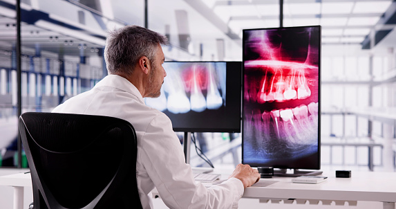 Radiologist Dentist Using X Ray Software On Desktop Computer