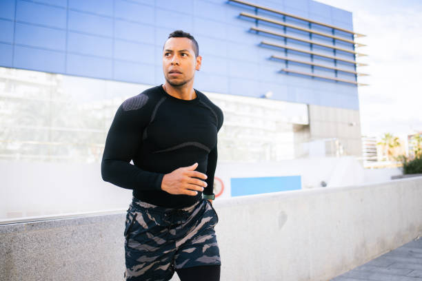 Portrait of a handsome mid adult man jogging in the city.